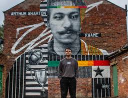 First black football professional honoured with mural