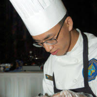 US Navy (USN) Culinary SPECIALIST Third (CS3) Class Guangfeng Zhou assigned  to the Naval Mobile Construction Battalion 4 (NMCB-4) prepares ingredients  during the Food Services Inc. Armed Forces"Iron Chef"Competition held at  Kadena