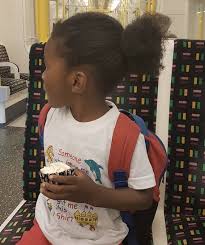 This is one of the easier looks for men with long hair. A Photograph Of A Ten Year Old Black Boy Sporting A Man Bun Hairstyle For His Long Kinky Curly Hair Long Hair Guys