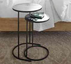 Built entirely of metal, it has a silhouette ring base that echoes the shape of the circular disc top. Duke 19 Round Metal Nesting Nightstand Pottery Barn