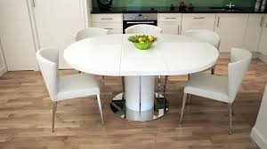The contrasting black upholstered chairs provide just the right look. Curva White Gloss Extending Dining Set Round Kitchen Table White Kitchen Table Dining Table