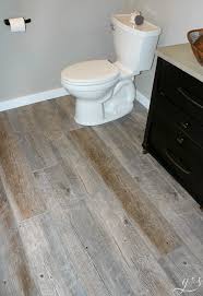 Diy How To Lay Floor Tile Planks Our Master Suite Bathroom Floor Is Rustic And Fun With The Light Ti Gray Wood Tile Flooring Grey Wood Tile Bathroom Flooring