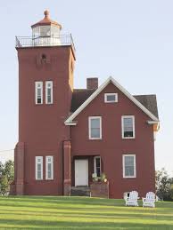 Minnesota's only operating lighthouse rises up over agate bay. Two Harbors Lighthouse Bed Breakfast Northern Wilds Magazine