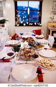 Imagine serving just a simple casserole and garlic bread for christmas. Christmas Meal Laid On Table In Decorated Dining Room Roasted Turkey Or Chicken Vegetables Cookies Christmas Wreath Canstock