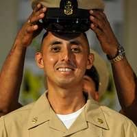 Chief Boatswain's Mate Matthew Willing is pinned by Chief Boatswain's Mate  Adam Melancon during a chief petty officer pinning ceremony.