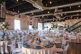 This beautifully renovated warehouse is simple yet elegant, with brick exterior and interior, loft ceilings, exposed lighting, and dock doors opening onto the patio. Brick Spring Wedding Wedding Gallery Aays Event Rentals