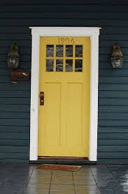 A yellow house with a rent front door and white trims is the perfect color palette for the exterior of a cottage home. Dark Blue House White Trim Yellow Door Novocom Top