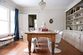 The wood is in a distressed finish. 10 Unexpected Combinations Between Modern Chairs And Country Tables