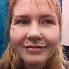 angel fangs" from earlier today. Angel fangs are a pair of vertical upper  lip piercings done with curved bars and quite often with a spike instead of  the bottom ball to give