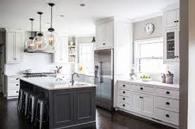 The original dark countertops were swamped out with white marble. You Ll Quickly See Why Beth Haley Is Our Latest Interior Designer Crush White Kitchen Design Grey Kitchen Island White Kitchen Remodeling