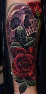 If you think a skull tattoo is a terrible one to sport, then lessen the frightening effect by associating roses, butterflies, and birds. 50 Skull Rose Tattoos Meanings Tattoo Designs More