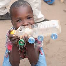How to build your own 8 Wheeler from recycle plastic bottle and caps. This  little guy was so excited to show off his toy, that he build himself, and  had to explain