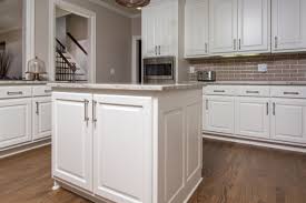 Hampton bay hampton satin white raised panel stock assembled sink base kitchen cabinet (36 in. Bright White Raised Panel Island With Granite Countertops And A Subway Backsplash Kitchen Design Beautiful Kitchens Granite Countertops