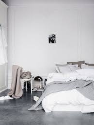 Bedroom Grey Polished Concrete Floor White And Grey Bedlinen High Ceilings Ornate Wall Panelling Moulding Concrete Bedroom Bedroom Trends Bedroom Flooring
