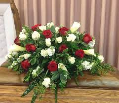 Casket Spray Of Red And White Roses Along With Calla Lilies Different Greens For Church Flower Arrangements Red Rose Arrangements Funeral Flower Arrangements