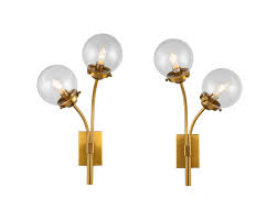 This hardwired wall lamp can be oriented facing up or down, is safe to use in damp locations, and is compatible with dimmer switches. Opal Brass Clear Glass Wall Lamp Set Of 2 Shop Now