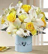 Sunny yellow roses nestle with crisp white asiatic lilies and alstroemeria (peruvian lilies), soft yellow mini carnations and fresh greenery to create this enchanting arrangement. Ftd Tiny Miracle New Baby Boy In Fort Myers Fl Angel Blooms
