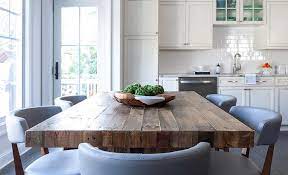 The plank dining table by gus* modern is a modern interpretation of the traditional harvest table, with a warm wood finish and legs that showcase solid wood endgrain flush with the table top. Blue Leather Chairs At Reclaimed Wood Plank Dining Table Transitional Dining Room