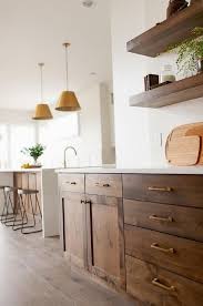 Home Decor Wall Gorgeous Brown Oak Shaker Cabinets Are Accented With Brass Pulls And A White Quartz Co In 2020 Brown Kitchen Cabinets Home Decor Kitchen Brown Kitchens