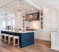 This industrial modern kitchen features a concrete countertop, wood cabinets and black hardware. Cabinets Your Common Questions Answered Seriously Happy Homes