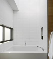 It features an almost full subway tile all around the walls up until the bathtub's, only leaving some space before the ceiling. Rammed Earth House By Ccs Architecture Remodelista Modern Bathroom Bathroom Design Subway Tile Design