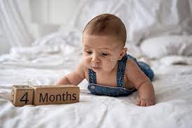 Adorable Four Month Old Baby Boy In Denim Dungarees Lying On White Bed Stock Image Image Of Funny Horizontal 217567797