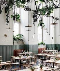 theshopinterior on instagram from mk interior design ランタンのようなペンダントライトと つる性観葉植物を天井からたくさんぶら下げた 庭園風の店内 天井が高いせいか 色 レストランのデザイン カフェのインテリアデザイン カフェ インテリア 内装