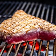 Cover the tuna steaks with soy sauce, oil, salt, and pepper. How To Grill Tuna Steaks