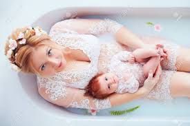 Milk bath flowers floral baby photo shoot #milkbath milk bath flowers floral bab. Young Happy Mother With Newborn Baby Girl Daughter In Floral Milk Bath Family Look Outfit Stock Photo Picture And Royalty Free Image Image 116454445