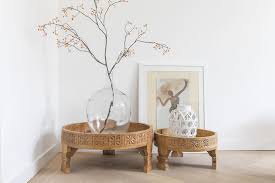 A wonderful teak indian coffee table having carved decoration and iron strap work decoration. Hand Carved Chakki Tables Of Mango Wood Simply Pure Simply Pure Online Interior Boutique And Styling Design Studio