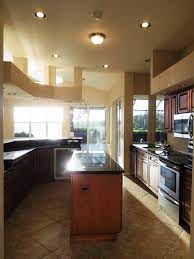 Kitchen With A Pantry Wood Grain Cabinets A Center Island Granite Countertops Tile Backsplash A Breakfast Bar Overloo Bonita Springs Room Breakfast Home