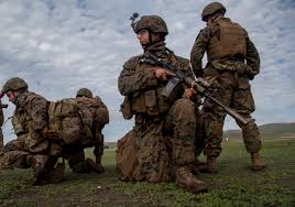 Marine Corps Lance Cpl. Mark Jerry, middle, covers fellow Marines during  realistic urban training
