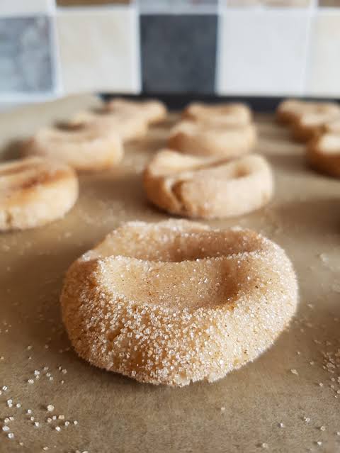 Image result for Roll the dough into small balls, fill the other bowl with white sugar, then roll each ball in the sugar until it is completely coated.Then, place the balls on the prepared baking pan.