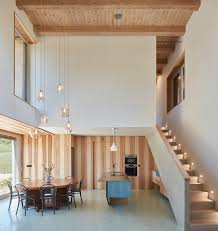 In the dining area, a saarinen tulip table is surrounded by hans wegner. House Inside A Ruin By Ora Dwell