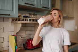Woman Drinks From A Bag In A Kitchen by Stocksy Contributor Julie Meme -  Stocksy