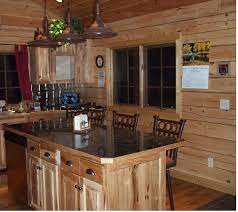 The pine rustic kitchen cabinets in this log cabin kitchen, contrast nicely with the darker tile floor. Choosing Kitchen Cabinets Cabinet Decorative Hardware Kitchen Cabinet Decor