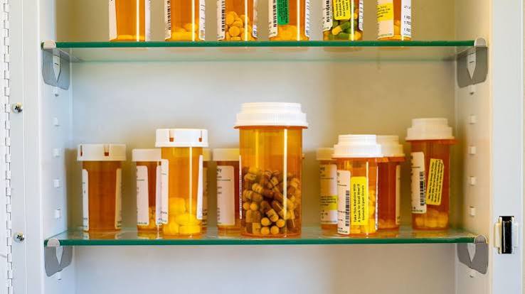 Multiple prescription pill bottles grouped together, representing the risk of combining several medications