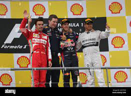 The podium (L to R): Fernando Alonso (ESP) Ferrari, second; Michael  Manning(IRE)Red Bull Racing Trackside Control Engineer; Sebastian Vettel  (GER) Red Bull Racing, race winner; Lewis Hamilton (GBR) Mercedes AMG F1,  third.