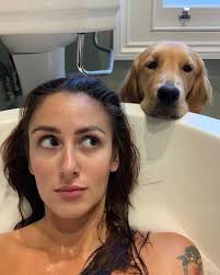 Dog loves owner's bath time