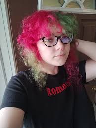 Non-binary individual shares photos for self-esteem and community connection