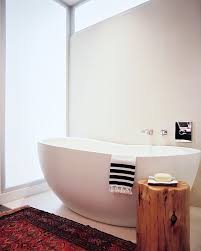 View of bathtub with side table and towel on sea view background,modern interior design with timber and white wall. Little Luxury 30 Bathrooms That Delight With A Side Table For The Bathtub