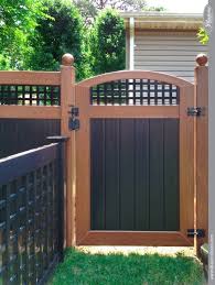 Quality interstate wholesale fence manufactures products that are designed, tested and proven to last today and into the future. Black And Wood Grain Pvc Vinyl Accent Gate With Lattice From Illusions Fence Backyard Fences Privacy Fence Designs Backyard