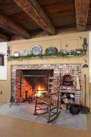 The tv console fireplace features functional forged iron. The Homeowners Salvaged Vintage Bricks And Worked With A Local Mason To Turn Them Into A Colonial Style Kitchen Fireplace Colonial Kitchen Farmhouse Fireplace