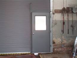 Roll Down Door With Man Door Closed Roll Down With Pass Door Commercial Overhead Door Overhead Door Roll Up Doors