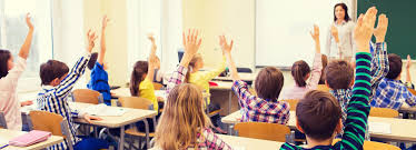 Classroom Full Of Students Raising Their Hands To Participate As The Teacher Watches Elementary Activities Math Tutor Kids School