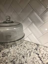 White Gray Kitchen Makeover Granite Countertop And Herringbone Subway Tile Granite Countertops Kitchen Grey Granite Countertops Refinish Kitchen Cabinets