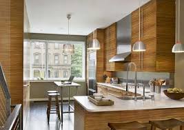 Light cabinetry and stainless steel appliances make a bold statement. Zebrawood Kitchens