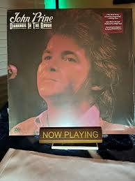 John's best friend was the late great Steve Goodman, and they sang one of  John's greatest songs together, incomparable "Souvenirs." I'm a huge fan of  Steve, and you should get his compilation