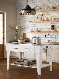 I love the wood stain color of the wood because it's so deep and rich and is a really good contrast to the antique mason jars and all the other white in the kitchen. Magnolia Home Kitchen Island Jo S White Farmhouse Kitchen Houston By Star Furniture Houzz
