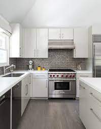 You cannot wait to see the countertop, the floor, the backsplash and so on. White And Gray Kitchen With Gray Mini Brick Tile Backsplash Contemporary Kitchen